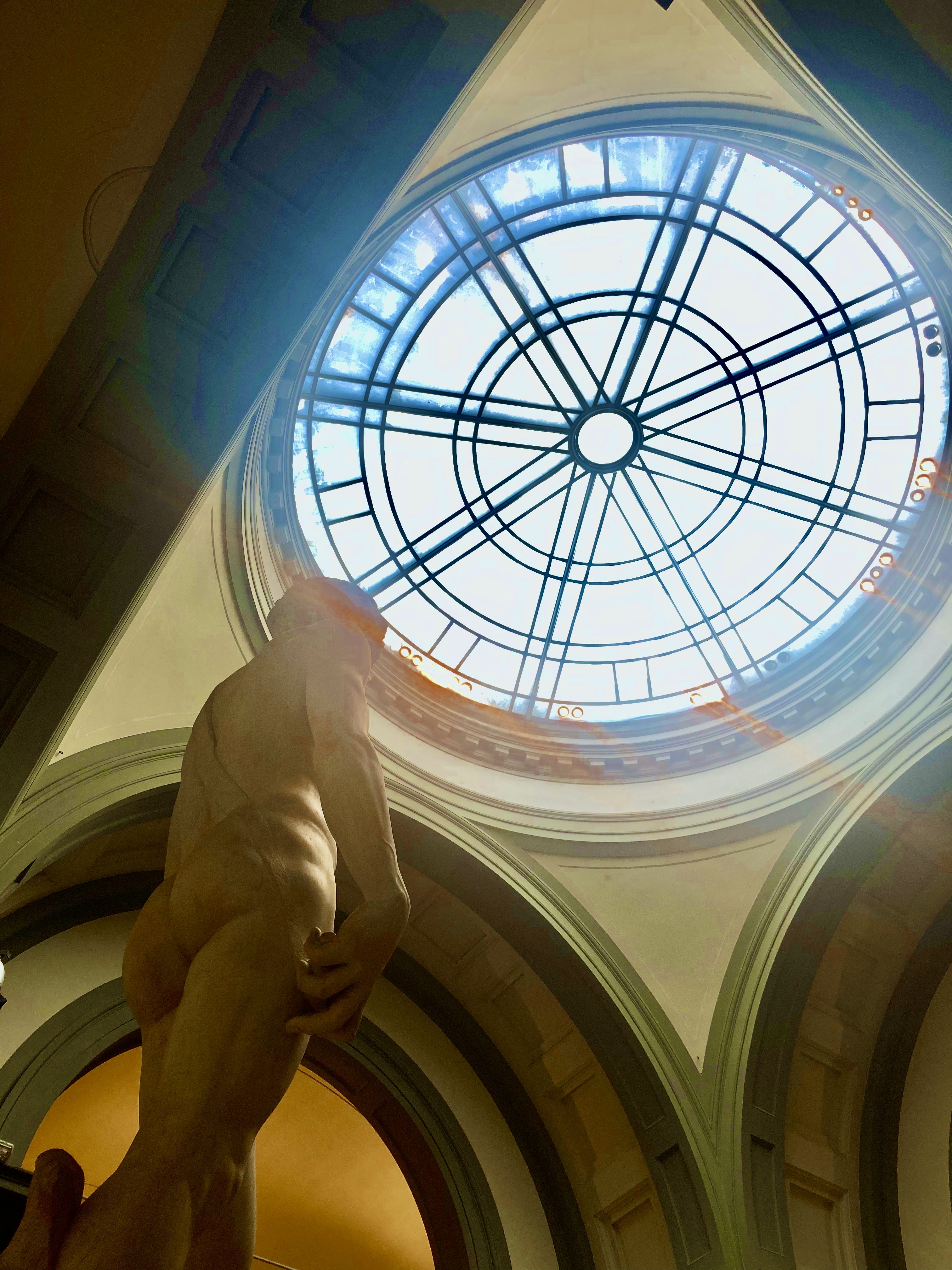 A photo of Michaelangelo's David, taken at an angle.